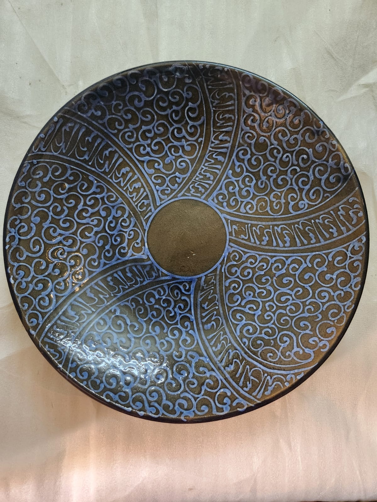Deep blue ceramic plate adorned with an elaborate