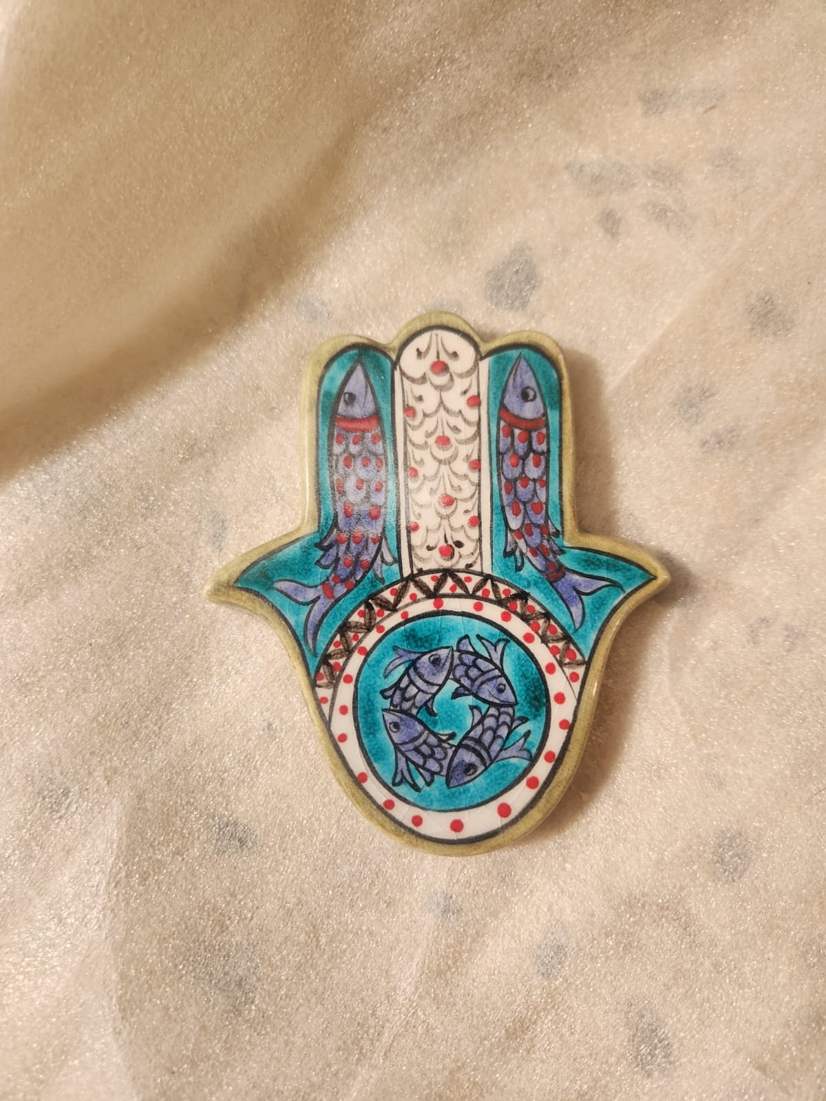 A ceramic polychrome protective hand